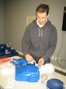 Applying AED pads during CPR training